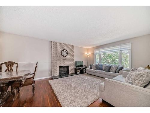 735 Madeira Drive Ne, Calgary, AB - Indoor Photo Showing Living Room With Fireplace