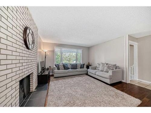 735 Madeira Drive Ne, Calgary, AB - Indoor Photo Showing Living Room With Fireplace