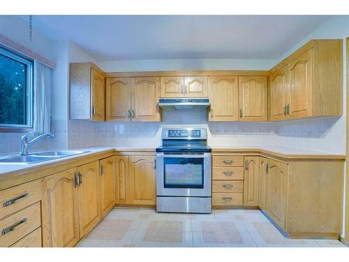 106 Sienna Hills Drive Sw, Calgary, AB - Indoor Photo Showing Kitchen With Double Sink