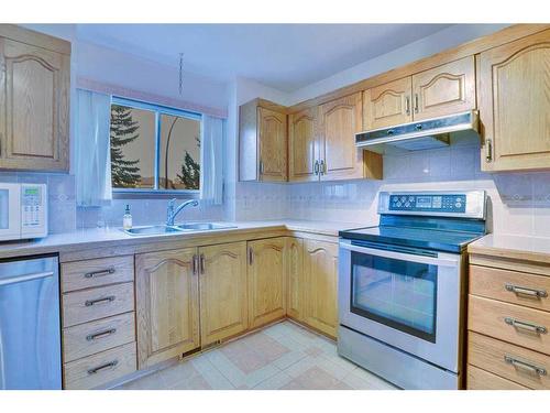 106 Sienna Hills Drive Sw, Calgary, AB - Indoor Photo Showing Kitchen With Double Sink