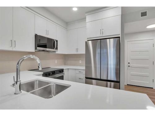 115-125 Wolf Hollow Crescent Se, Calgary, AB - Indoor Photo Showing Kitchen With Stainless Steel Kitchen With Double Sink