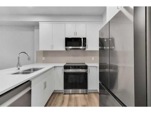 115-125 Wolf Hollow Crescent Se, Calgary, AB - Indoor Photo Showing Kitchen With Double Sink