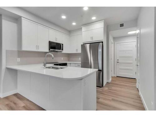 115-125 Wolf Hollow Crescent Se, Calgary, AB - Indoor Photo Showing Kitchen With Stainless Steel Kitchen With Double Sink