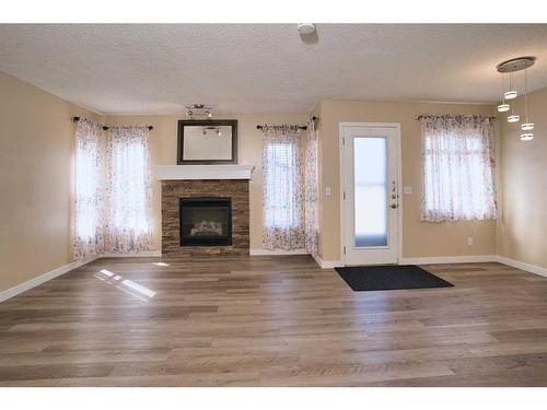 9221 Saddlebrook Drive Ne, Calgary, AB - Indoor Photo Showing Living Room With Fireplace