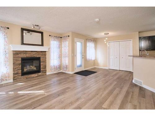 9221 Saddlebrook Drive Ne, Calgary, AB - Indoor Photo Showing Living Room With Fireplace