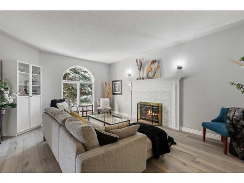 145 Candle Place Sw, Calgary, AB - Indoor Photo Showing Living Room With Fireplace