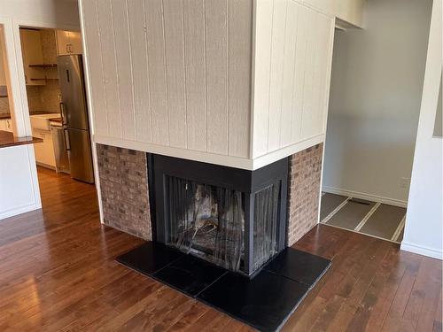 1401-2520 Palliser Drive Sw, Calgary, AB - Indoor Photo Showing Living Room With Fireplace