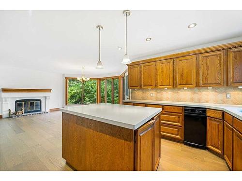 123 Coach Light Bay Sw, Calgary, AB - Indoor Photo Showing Kitchen With Fireplace