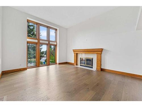 123 Coach Light Bay Sw, Calgary, AB - Indoor Photo Showing Living Room With Fireplace