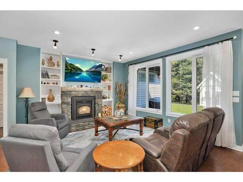 705 5 Street Sw, Sundre, AB - Indoor Photo Showing Living Room With Fireplace