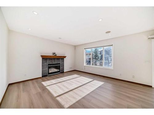 434 Saddlecreek Way Ne, Calgary, AB - Indoor Photo Showing Living Room With Fireplace