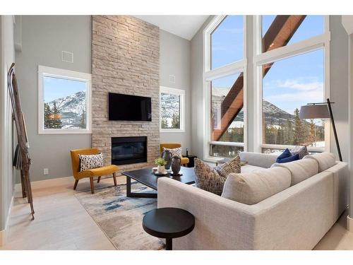 201-2100E Stewart Creek Drive, Canmore, AB - Indoor Photo Showing Living Room With Fireplace