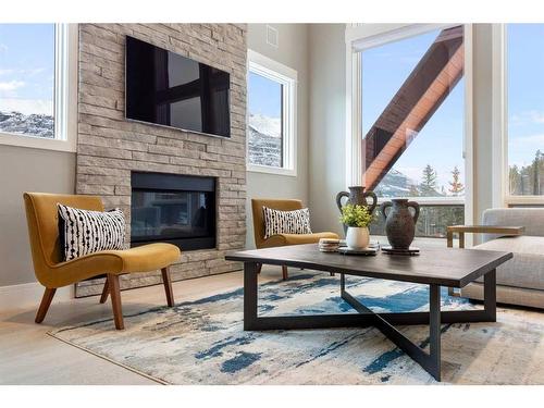 201-2100E Stewart Creek Drive, Canmore, AB - Indoor Photo Showing Living Room With Fireplace