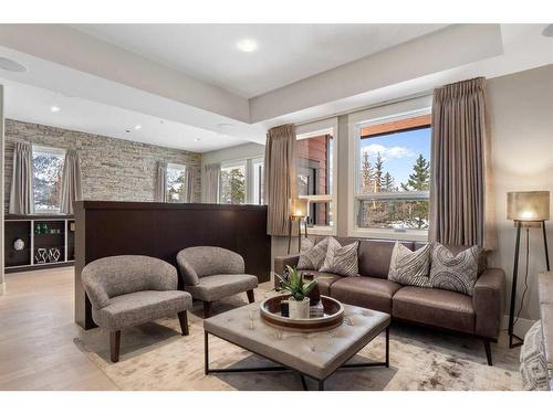 201-2100E Stewart Creek Drive, Canmore, AB - Indoor Photo Showing Living Room