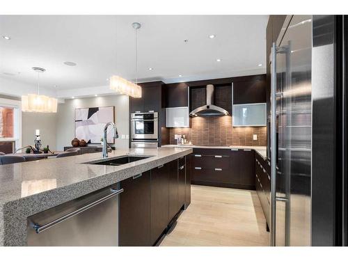 201-2100E Stewart Creek Drive, Canmore, AB - Indoor Photo Showing Kitchen With Upgraded Kitchen