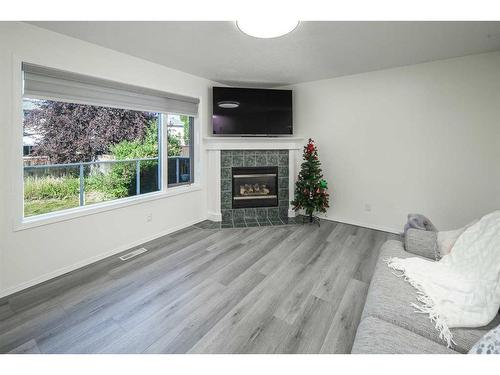 103 Tuscany Ridge View Nw, Calgary, AB - Indoor Photo Showing Living Room With Fireplace