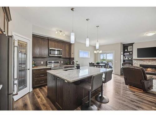 2132 Ravensdun Crescent Se, Airdrie, AB - Indoor Photo Showing Kitchen With Fireplace With Stainless Steel Kitchen With Upgraded Kitchen