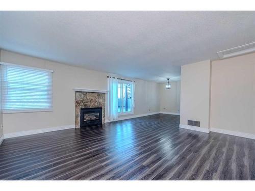 217-36 Glamis Green Sw, Calgary, AB - Indoor Photo Showing Living Room With Fireplace