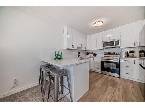 138-3015 51 Street Sw, Calgary, AB - Indoor Photo Showing Kitchen With Stainless Steel Kitchen With Upgraded Kitchen