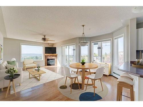 306-345 Rocky Vista Park Nw, Calgary, AB - Indoor Photo Showing Dining Room With Fireplace