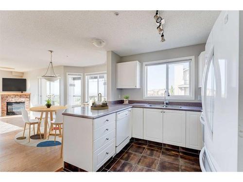 306-345 Rocky Vista Park Nw, Calgary, AB - Indoor Photo Showing Other Room With Fireplace