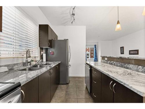 1217-604 East Lake Boulevard Ne, Airdrie, AB - Indoor Photo Showing Kitchen With Double Sink