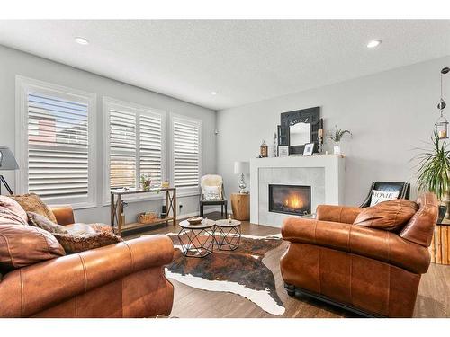 203 Bayview Circle Sw, Airdrie, AB - Indoor Photo Showing Living Room With Fireplace