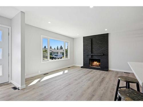 139 Bracewood Road Sw, Calgary, AB - Indoor Photo Showing Living Room With Fireplace