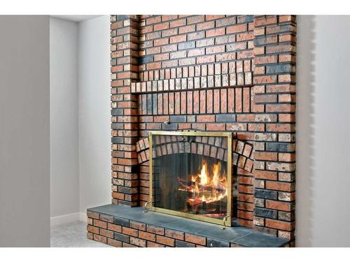 139 Bracewood Road Sw, Calgary, AB - Indoor With Fireplace