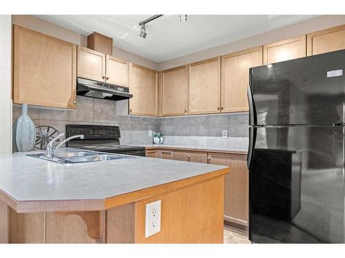 3203-92 Crystal Shores Road, Okotoks, AB - Indoor Photo Showing Kitchen With Double Sink