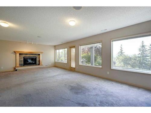 7823 Springbank Way Sw, Calgary, AB - Indoor Photo Showing Other Room With Fireplace