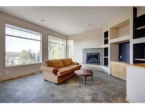 7823 Springbank Way Sw, Calgary, AB - Indoor Photo Showing Living Room With Fireplace