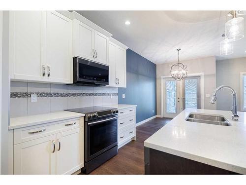 20 Stone Garden Crescent, Carstairs, AB - Indoor Photo Showing Kitchen With Double Sink