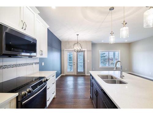 20 Stone Garden Crescent, Carstairs, AB - Indoor Photo Showing Kitchen With Double Sink With Upgraded Kitchen