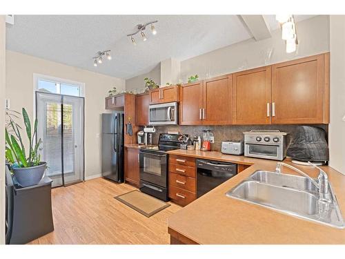 174 New Brighton Point Se, Calgary, AB - Indoor Photo Showing Kitchen With Double Sink