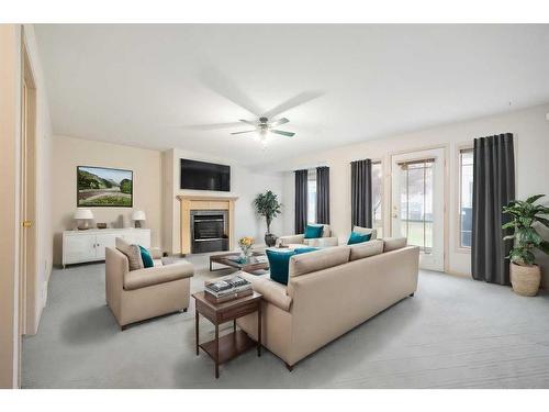 95-72 Millside Drive Sw, Calgary, AB - Indoor Photo Showing Living Room With Fireplace