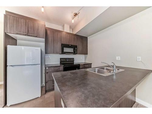 198-300 Marina Drive, Chestermere, AB - Indoor Photo Showing Kitchen With Double Sink