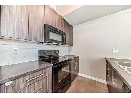 198-300 Marina Drive, Chestermere, AB - Indoor Photo Showing Kitchen With Double Sink