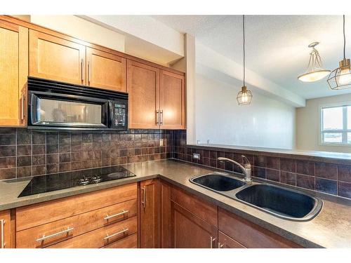 308-26 Val Gardena View Sw, Calgary, AB - Indoor Photo Showing Kitchen With Double Sink