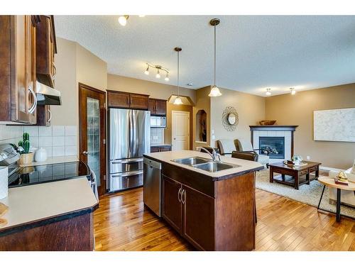 73 Cranwell Green Se, Calgary, AB - Indoor Photo Showing Kitchen With Fireplace With Double Sink With Upgraded Kitchen