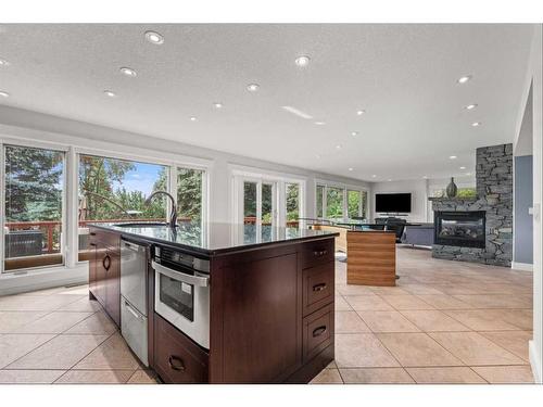 60 Deerbrook Crescent Se, Calgary, AB - Indoor Photo Showing Kitchen With Fireplace