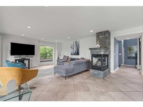 60 Deerbrook Crescent Se, Calgary, AB - Indoor Photo Showing Living Room With Fireplace