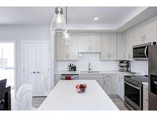 501-71 Shawnee Common Sw, Calgary, AB - Indoor Photo Showing Kitchen With Double Sink