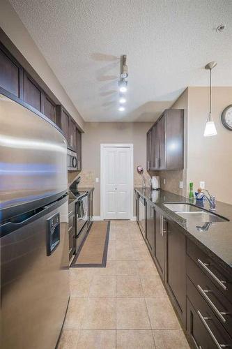 315-88 Arbour Lake Road Nw, Calgary, AB - Indoor Photo Showing Kitchen With Stainless Steel Kitchen With Double Sink