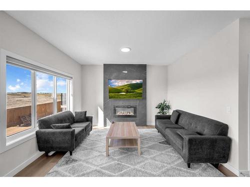 1021 Waterford Drive, Chestermere, AB - Indoor Photo Showing Living Room With Fireplace