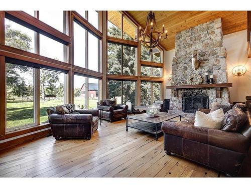 100-370025 288 Street West, Rural Foothills County, AB - Indoor Photo Showing Living Room With Fireplace