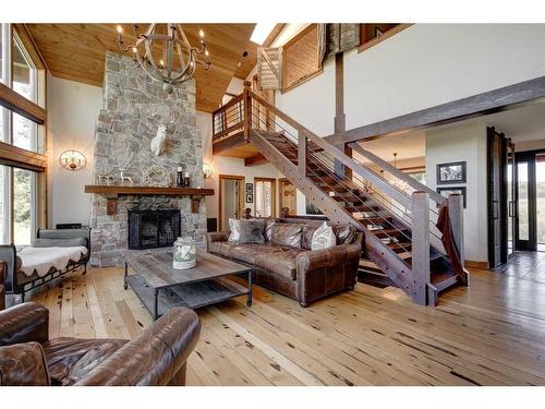 100-370025 288 Street West, Rural Foothills County, AB - Indoor Photo Showing Living Room With Fireplace