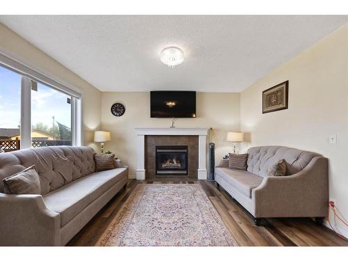 213 Saddlecrest Place Ne, Calgary, AB - Indoor Photo Showing Living Room With Fireplace