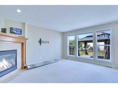 108 Rainbow Falls Grove, Chestermere, AB - Indoor Photo Showing Living Room With Fireplace