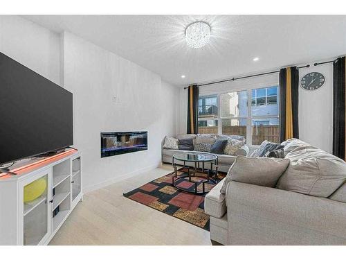 273 Ambleside Avenue Nw, Calgary, AB - Indoor Photo Showing Living Room With Fireplace